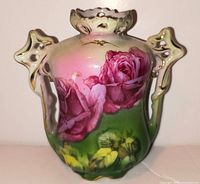 Front view showing rose decoration, handles and rim