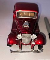 Front view showing grille, headlights, bumper, hood scoop