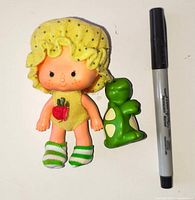 Apple Dumplin doll with Teatime Turtle figure beside size-reference marker