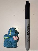 Front view Éclair poodle beside marker for scale