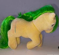 Left side view showing yellow flocked body, green tail, flank symbol