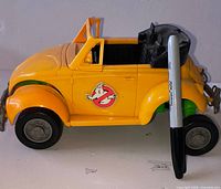 Left side view of yellow Highway Haunter toy with Sharpie for scale