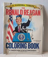 Front cover showing title, caricature of Ronald Reagan, 1988 date