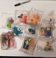 Group of sealed 1990s McDonald’s Happy Meal toys showing all ten unopened bags