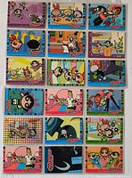 Front view of a binder page displaying 16 Powerpuff Girls trading cards including one holographic card
