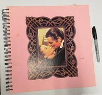 Front cover of spiral album with Rhett and Scarlett image, Sharpie for scale