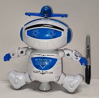 Full view of robot standing upright next to marker for scale