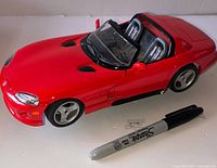 Left-front angle view of red Dodge Viper diecast with Sharpie for scale