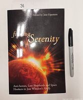Front cover of Finding Serenity book with marker for scale