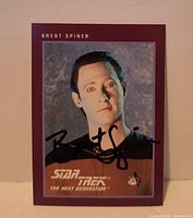 Front view of autographed Brent Spiner Star Trek: TNG trading card showing full image, border, logo, and signature
