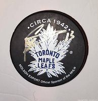 Front of puck showing team logo, sponsor text and Mats Sundin silver signature