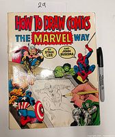 Front cover showing title, authors, Marvel characters, Sharpie for scale