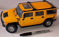 Left side three-quarter view showing body details and marker for scale