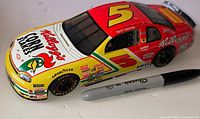 Left side profile of die-cast car beside Sharpie for scale
