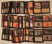 Stacks of roughly 100 Magic: The Gathering cards spread to show card fronts and backs