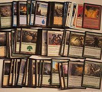 Spread of roughly 100 Magic: The Gathering cards showing variety of colors, card faces visible