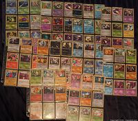 Overview of multiple binder pages showing large assortment of Pokémon cards