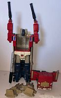 Super robot mode assembled showing cab, trailer armor, two mounted black blasters, beige panel parts in foreground
