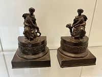 front view of both metal bookends showing figures and bases