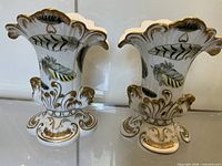 Pair of Chelsea House porcelain vases front view