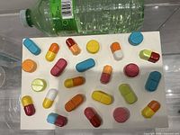 Full view of sculpture showing colourful pill capsules on white base