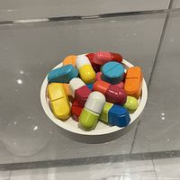 Top view of sculpture showing colourful pill forms on white base