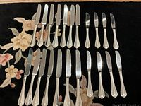 Full set of knives laid out to show quantity and pattern