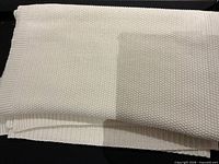Folded cream knit blanket showing overall appearance