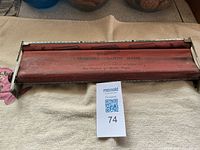 top view of metal cigarette maker showing roller and printed text