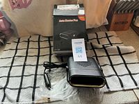 Heater fan, cord with lighter plug, plastic wrap, box visible