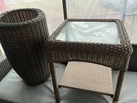 Square wicker table and tall wicker planter side by side