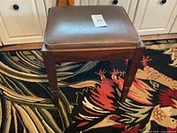 Front view of wooden bench with vinyl seat