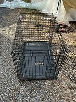 Overall view of metal wire dog crate with tray in place