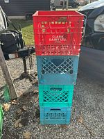 Full view of stack showing all four milk crates and visible branding on red crate