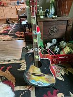 Front view showing Beatles artwork, soundhole, pickup control
