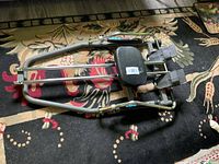 Top view of entire rowing machine showing frame, seat, hydraulic cylinders and footrests