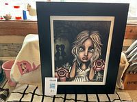 Overall view of framed signed print on table