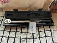 Torque wrench in open case on cloth