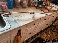 Full view of wooden straight bow on countertop