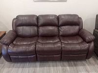 front view of three-seat bonded leather reclining sofa