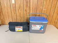 Cooler and sleeping bag side by side for scale and completeness