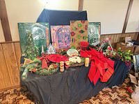 full table overview showing boxed lights, greenery, bows, serving pieces