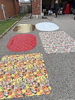 All five tablecloths laid out to show colours, patterns and relative sizes