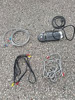 Group photo showing APC surge protector and four RCA cables laid out for identification