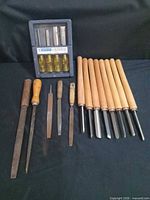Full lot overview: carving chisel set, five files/rasps, eight lathe chisels