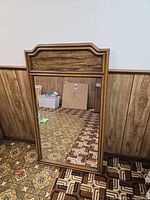 Front view showing wood frame, arch top, and mirror glass