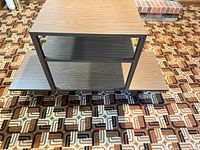 Side table front view showing top, middle shelf, lower offset shelf