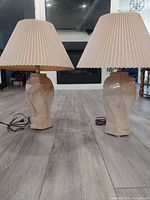 Front view of both ceramic table lamps with shades