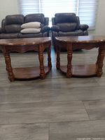 Pair of demi-lune end tables front view
