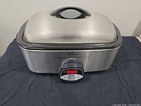 Front view of Rival 20-quart programmable roaster oven with lid and control panel visible